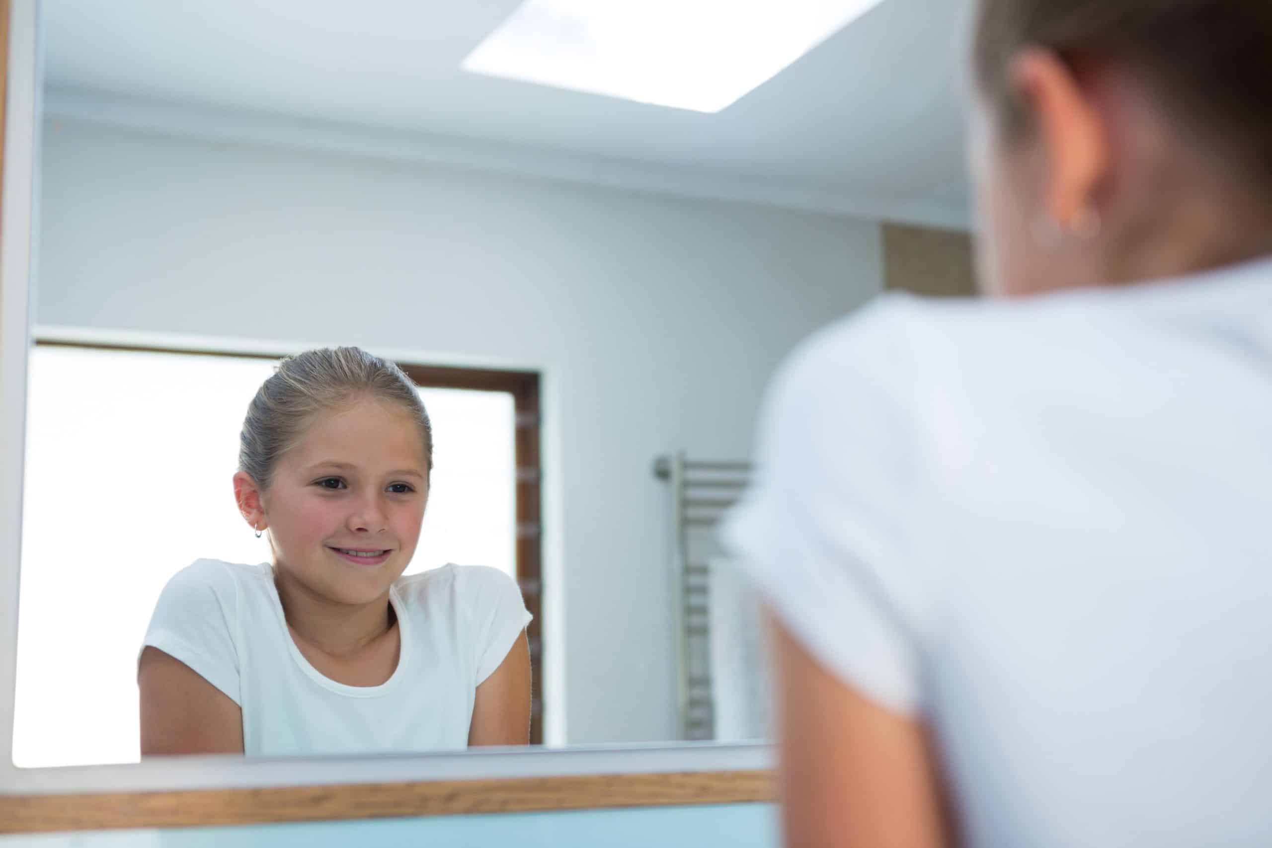 image of girl looking in mirror